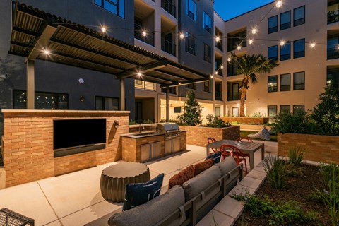 an outdoor living area with a fireplace and a television